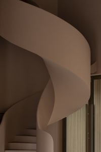 A modern interior space with a curved wooden wall, suggesting a stylish and contemporary design