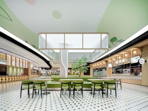 Open modern restaurant interior with green tables and chairs, multiple seating options, and a comfortable atmosphere