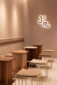 A dimly lit restaurant interior with wooden tables and chairs, creating a cozy atmosphere