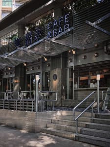 Spacious Asian restaurant with multiple dining tables and chairs, gray and white tones, and an inviting atmosphere