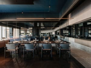 A spacious restaurant dining area with multiple tables and chairs, creating a diverse seating arrangement