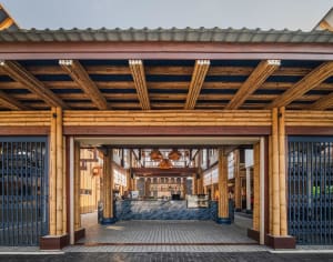 Open social space with wooden walls and ceiling, people walking and conversing