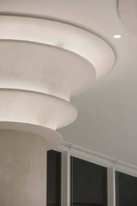 A modern white building featuring a spiral staircase with a clean and contemporary design, creating a calm and serene atmosphere