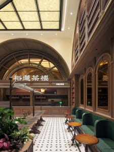 A well-lit dining area with tables and chairs in a modern Japanese restaurant, featuring a comfortable atmosphere and inviting ambiance