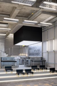 Bright and inviting lobby area with multiple tables and chairs, designed for dining and socializing