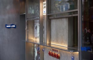 Industrial kitchen with a countertop featuring multiple red fire extinguishers and a utilitarian atmosphere