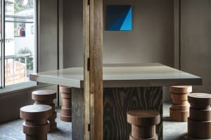 A warm and inviting dining area with a large wooden table, chairs, and couches, perfect for meals with friends and family