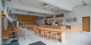 A warm and inviting kitchen with wooden floors, a dining table, and various kitchen appliances, with a focus on practicality and comfort