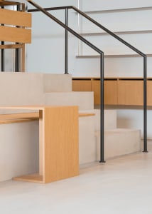 A warm and inviting interior staircase with two sets of wooden stairs leading upwards, adding elegance to the space