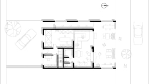 Modern living space with white walls, mixed wood and tile flooring, and a staircase leading to other levels, featuring a dining area, living room, and kitchenette