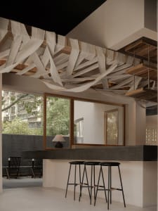 A well-lit restaurant bar area with a wooden counter, stools, and chairs, surrounded by inviting decor