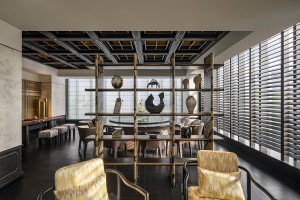 A well-lit dining area with multiple chairs, a dining table, and decorative vases on shelves, showcasing various styles and designs