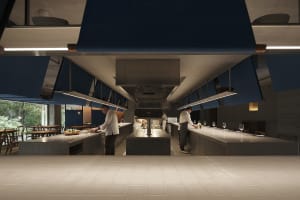 Industrial kitchen with a large oven, wine glasses, and a professional atmosphere