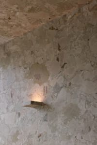 A marble wall with a stone design in a bathroom, part of an old building, exuding luxury and elegance