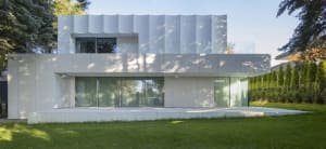 A sleek modern building with a white facade, multiple windows, and clean lines, suggesting a sense of elegance and sophistication