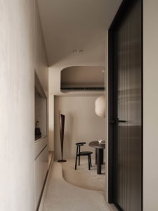 A cozy dining space with a black table surrounded by two chairs, creating a warm and inviting atmosphere