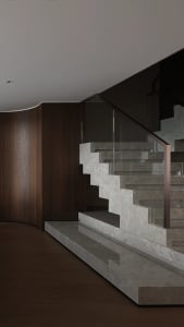 A traditional staircase with wooden steps, leading to another level in a building, with natural light and a sense of simplicity and elegance