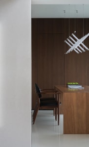 A warm and inviting dining space with a wooden table and chairs, surrounded by a brown color scheme and natural light