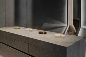 A kitchen countertop made of marble displays four types of cakes in an organized manner, creating a cozy and inviting atmosphere