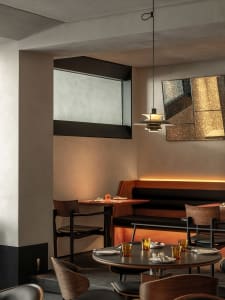 Empty restaurant interior with dining tables and chairs, creating a comfortable atmosphere for guests
