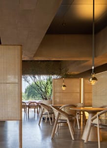 Modern restaurant interior with wooden tables and chairs, warm atmosphere, and inviting ambiance