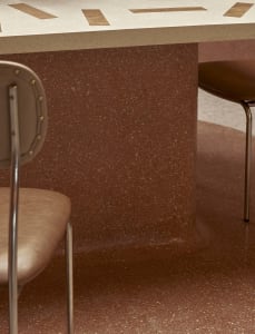 Warm and inviting kitchen space with a brown marble countertop, two chairs, and a luxurious ambiance