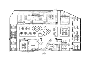 2D floor plan of a modern office complex with various rooms and spaces, including a lobby, hallways, offices, and dining areas, featuring neutral tones and clean lines