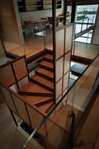 A photo of a well-lit stairwell with wooden stairs, creating a bright and inviting atmosphere