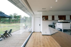 Open living area with hardwood flooring, a dining table, chairs, and decorative elements