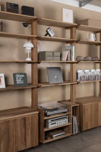 A well-organized bookshelf with books and a record player, creating a cozy atmosphere for reading and listening to music