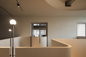 Empty white room with two doorways, one on each side, and a clean minimalist design