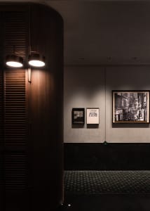 An art gallery with framed pictures on display at different heights on the wall, creating a visually appealing atmosphere