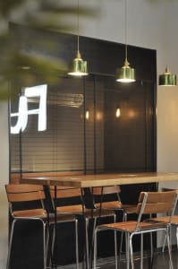 A cozy dining area with a long wooden table and multiple chairs, surrounded by warm and inviting atmosphere