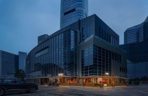 A modern building with a glass facade, multiple windows, and a contemporary urban atmosphere