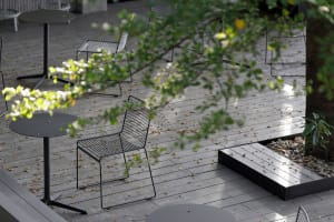 A patio area with metal chairs arranged around a dining table, creating a relaxed and inviting atmosphere for outdoor dining