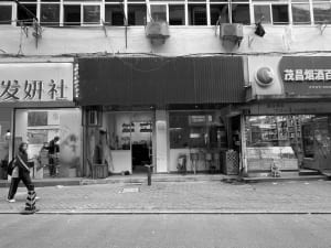 Inviting storefront with a black awning, chairs, and a dining table, creating a comfortable shopping experience