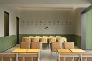 Empty classroom with wooden tables and chairs arranged in rows, creating a calm and quiet learning environment