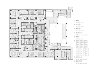 2D floor plan of a modern hotel with various rooms and spaces, including a lobby, dining area, and multiple bedrooms, with detailed measurements and furniture placements