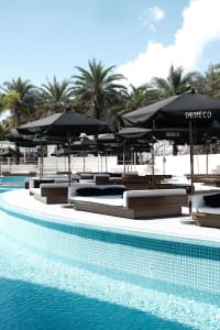 A pool area with lounge chairs, umbrellas, and a comfortable atmosphere for relaxation