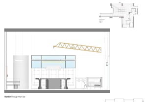 Modern office space with a bar, dining area, and office spaces featuring chairs, a couch, and a comfortable atmosphere