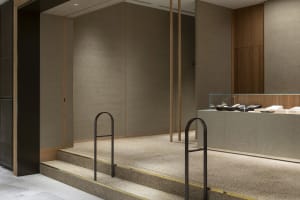 A well-lit office space with wooden staircases, large windows, and a welcoming atmosphere