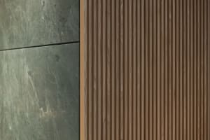 A modern interior space with a wooden wall featuring brown wood panel design, creating a sense of depth and visual interest
