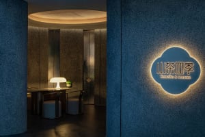 Sleek modern office space with a circular wall, two chairs, and a dining table