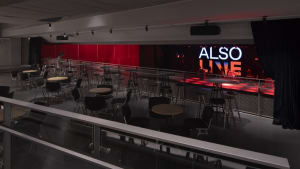 Modern restaurant interior with multiple dining tables and chairs, couches, and a welcoming atmosphere