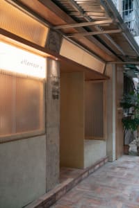 Two modern rooms with glass walls, potted plants, and a well-designed interior