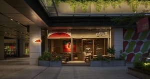 Modern Asian restaurant with a large dining area, potted plants, artwork on the walls, and comfortable seating
