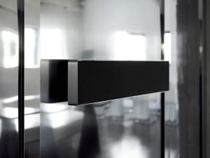 Modern interior design with a sleek glass door, clean lines, and minimalistic elements