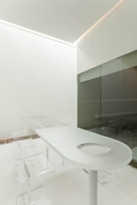 Empty modern bathroom with a glass sink in the center, giving a clean and minimalist appearance
