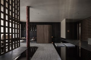 Cozy modern dining space with a wooden floor, black and white color scheme, and a dining table with several bowls