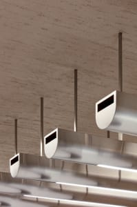 A modern space with a ceiling featuring multiple silver pipes arranged in various directions, creating a unique design element